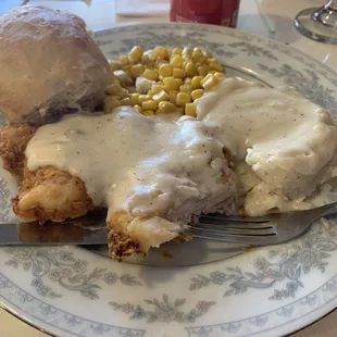 Chicken fried chicken with mashed potatoes and gravy, corn and one of their homemade biscuits.