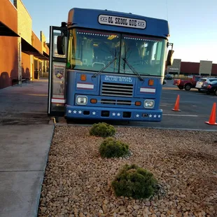  blue bus parked in a parking lot