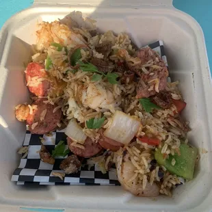 shrimp and rice in a styrofoam container