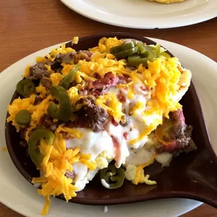 Skillet with biscuits, eggs, bacon, jalapeños, gravy, hash browns. Very good!