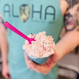 a person holding a bowl of ice cream