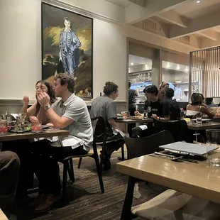 a group of people eating in a restaurant