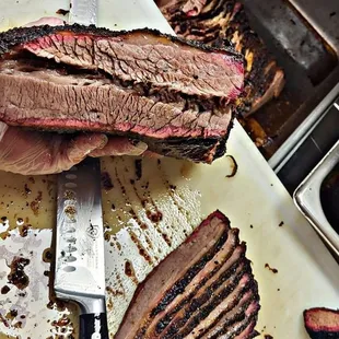 a cutting board with meat on it