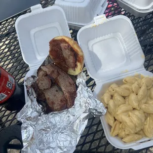 Brisket sandwich with barbecue sauce . Mac and cheese