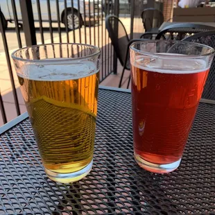 two glasses of beer on a table