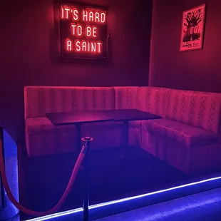 a booth with a neon sign