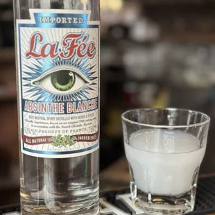 a bottle of liquor and a shot glass