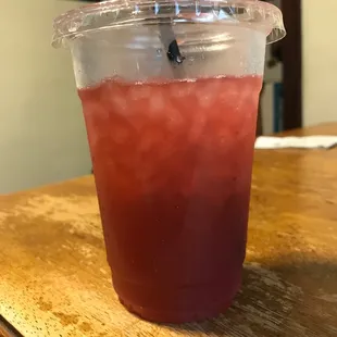 a drink in a plastic cup with a straw