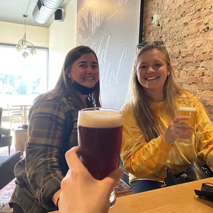 two women enjoying a beer