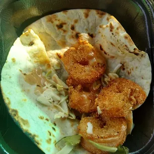 Shrimp taco with (4) shrimp and a couple of strands of cabbage