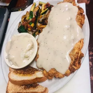 Chicken fried steak mixed veggies and mashed potatoes with gravy