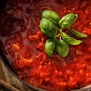 tomato sauce with basil leaves