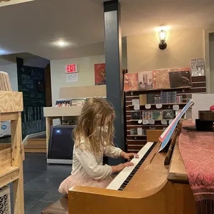 a little girl playing the piano