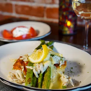 a plate of food and a glass of wine