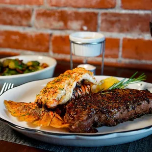 a plate of steak and a glass of wine