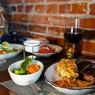 a woman eating dinner with a glass of wine