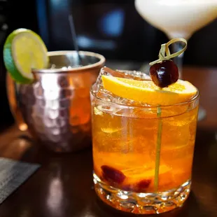 a cocktail with a garnish on top