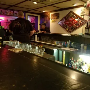 a bar with people sitting at the bar