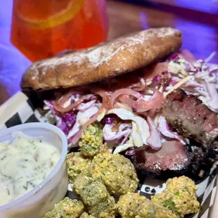 El Rico Chico - grass fed smoked brisket, slaw, pickled onions, and our hot dijon honey sauce.