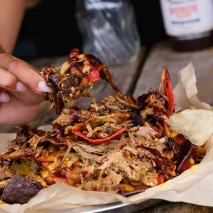 Country Nachos: tortilla chips topped with pulled pork, house-made Worcestershire sauce, cheese sauce, baked beans, and beer BBQ sauce.