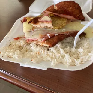 a plate of food with rice and meat