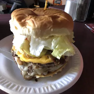 a cheeseburger on a paper plate