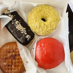 Boston Crème (upper left); Butter Pistachio (upper right); Crème Brûlée (bottom left); Raspberry Glazed (bottom right)!
