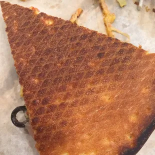 a burnt piece of pizza
