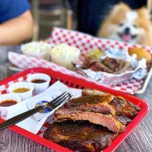 1/2 Rack Ribs, a la carte ($18) + 1/2 lb Smoked Brisket Plate w/ potato salad, coleslaw, corn muffin ($18.99)
