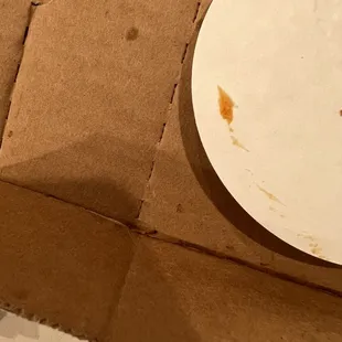 a white plate on a cardboard box