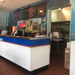 The front count and kitchen. Menu on the wall.