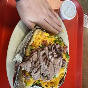 Brisket baker potato, hand for scale. Delicious and massive!