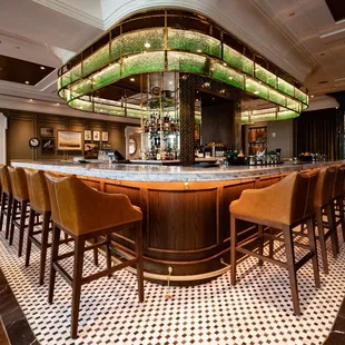  bar with chairs and a chandelier