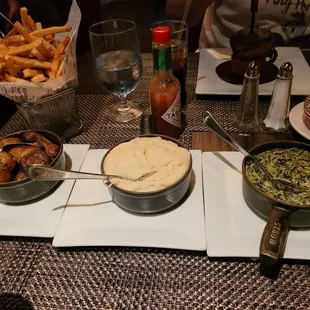 The Hand Cut Fries, The Sautéed Mushroom Caps, The Garlic Mashed Potatoes, and The Creamed Spinach.