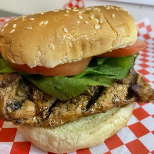 a chicken sandwich with lettuce and tomato