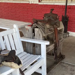 a white bench and a saddle
