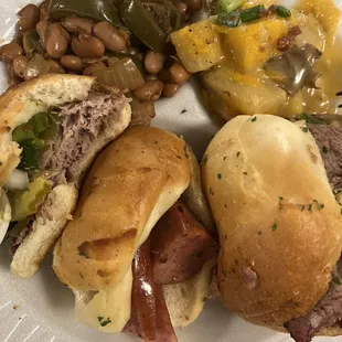 Slider plate with pork, sausage, and brisket. Sides are jalapeño Pinot beans and cheese potatoes.