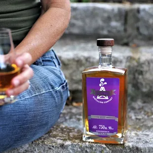 a woman holding a glass of whiskey