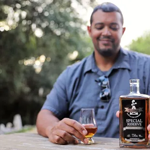 a man holding a glass of whiskey