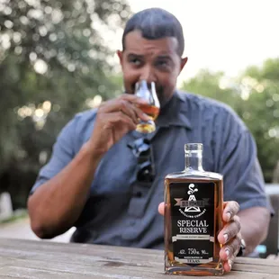 a man holding a bottle of whiskey
