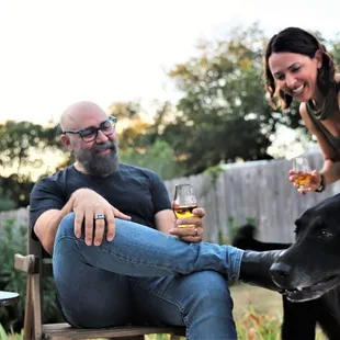 a man and woman with a dog