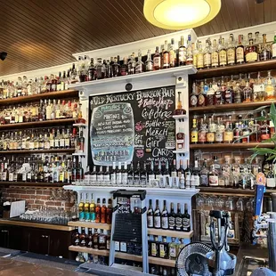 a woman standing in front of the bar