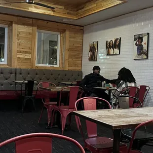 a restaurant with red chairs and tables