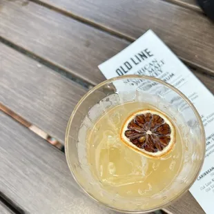 an orange slice in a cocktail glass
