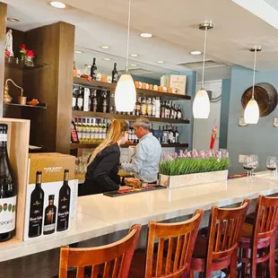 a bar with wine bottles on the counter