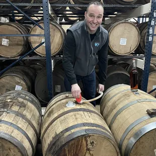 a man in a warehouse with barrels