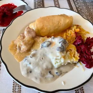 Buffet items; stuffed cabbage, mushroom gravy over mashed potatoes, pork stew, cabbage and beets.