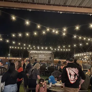 a large group of people eating outdoors