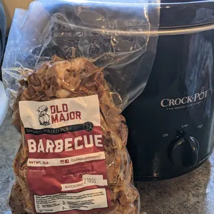 a bag of barbecue wood chips next to a slow cooker