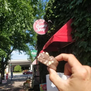 a hand holding a piece of candy